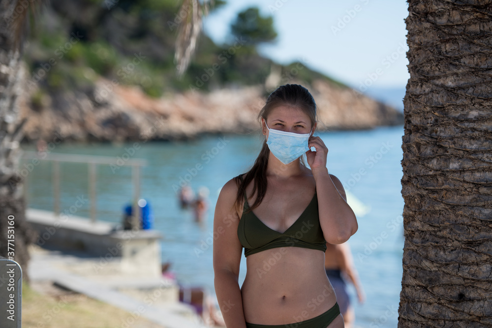 Young woman on the beach during the covid19