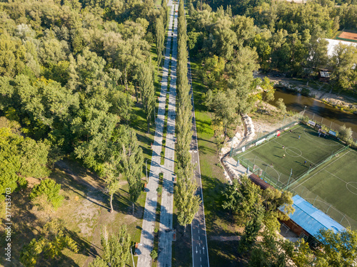 Aerial drone view. Cycling and walking path in the city park
