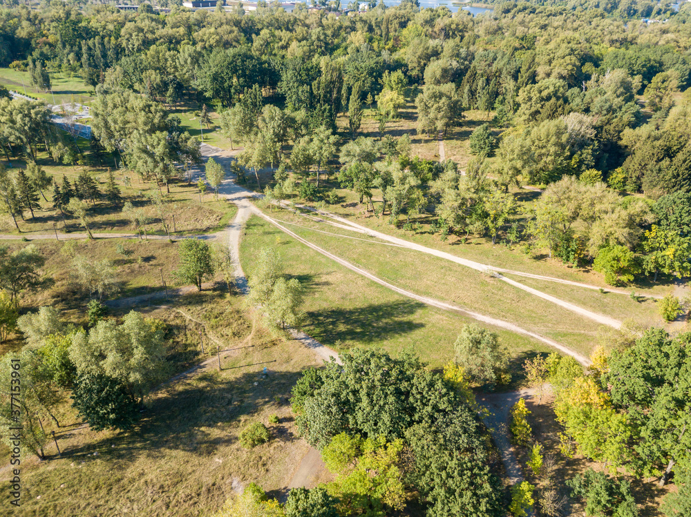 Aerial drone view. Dirt path in the city park Aerial drone view. Dirt path in the city park