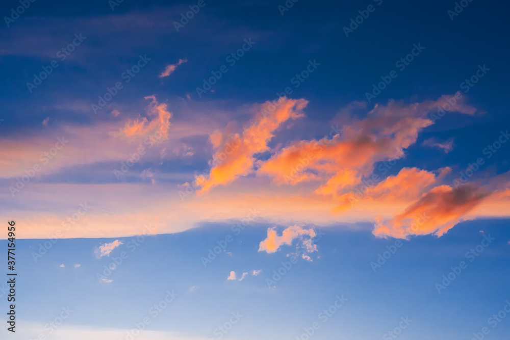 orange clouds on a blue sky at sunset or sunrise