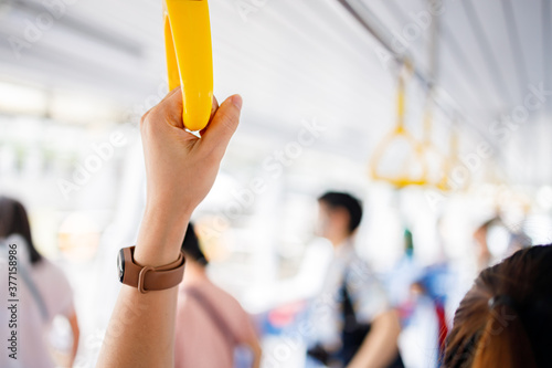 closeup woman hand holding handrail (grip) inside a train.