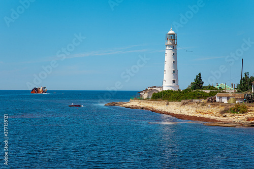 Blue sea lanscape with white lighthouse on foreland © Kisika