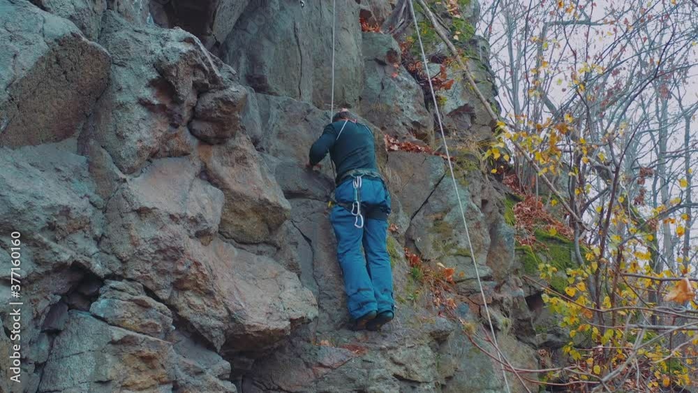 man climbing a rock. Extreme sports and adventures concept man climbing a rock. Extreme sports and adventures concept