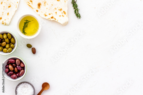 Italian olives, oil, bread - appetizer and snacks - top view copy space