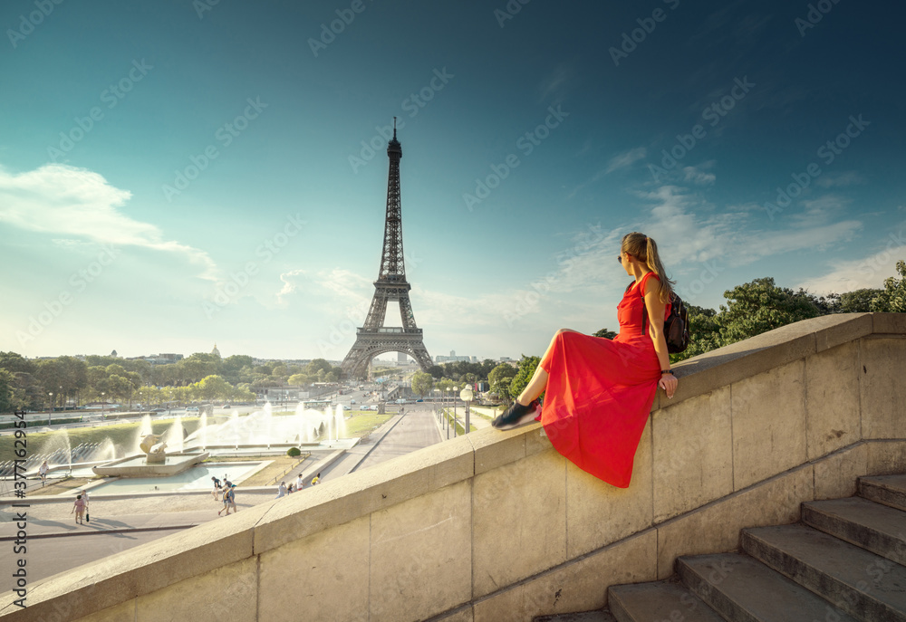 Young woman in red, looking to Eiffel tower, Paris