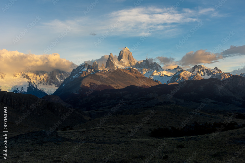 Golden autumn scenery, beautiful snow-capped mountains and blue sky and white clouds. Travel in Argentina.