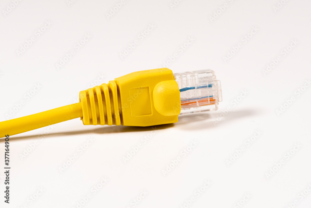 Yellow Network Cable with molded RJ45 plug isolated against white background. Yellow Network Cable with molded RJ45 plug isolated against white background.