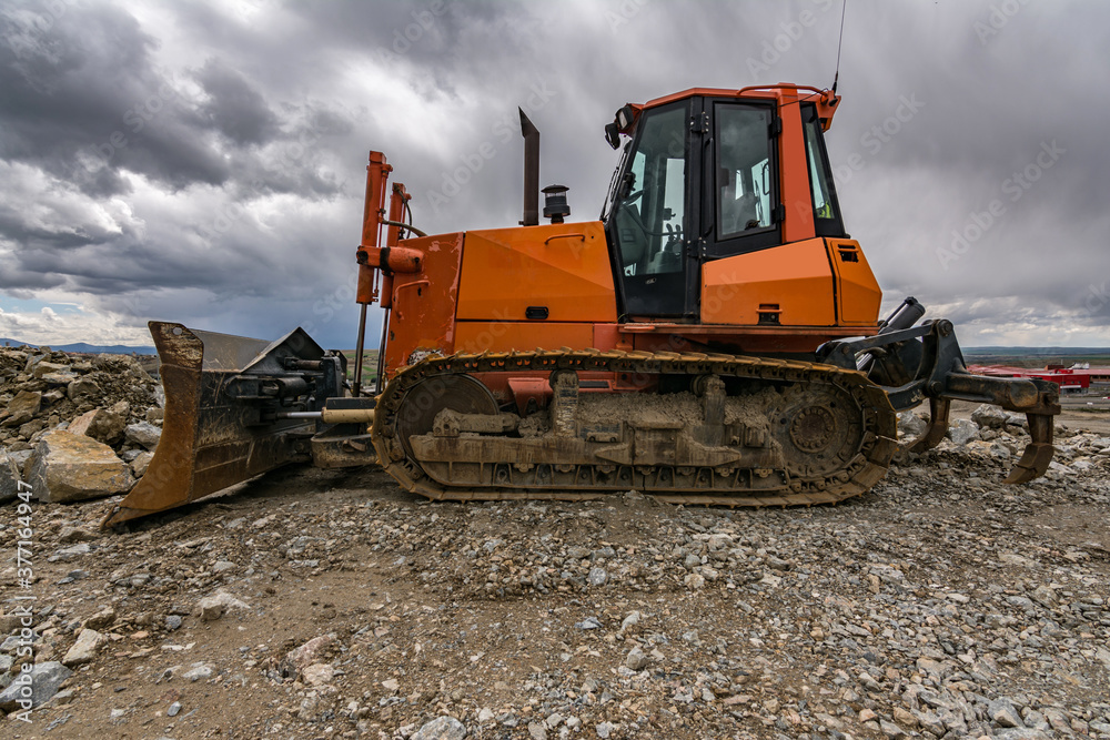 Excavator in a quarry extracting stone and rock Excavator in a quarry extracting stone and rock