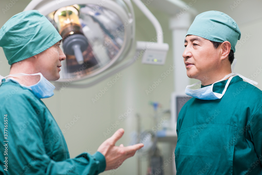 Surgeons talking in operating room Surgeons talking in operating room