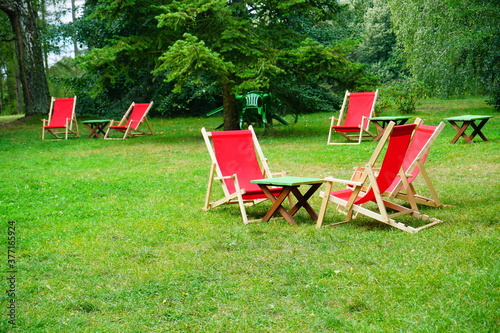 wooden deckchair in red color - relax, rest in the fresh air