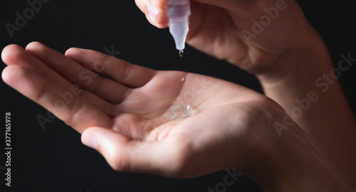 Person washing a contact lens with serum