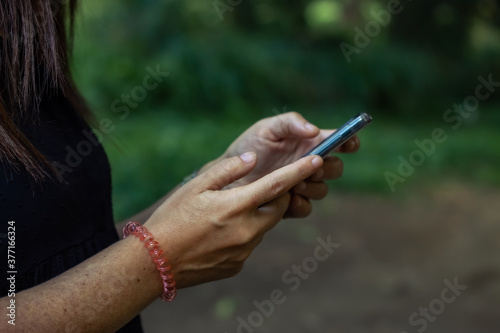 woman looking for information on her mobile phone while walking
