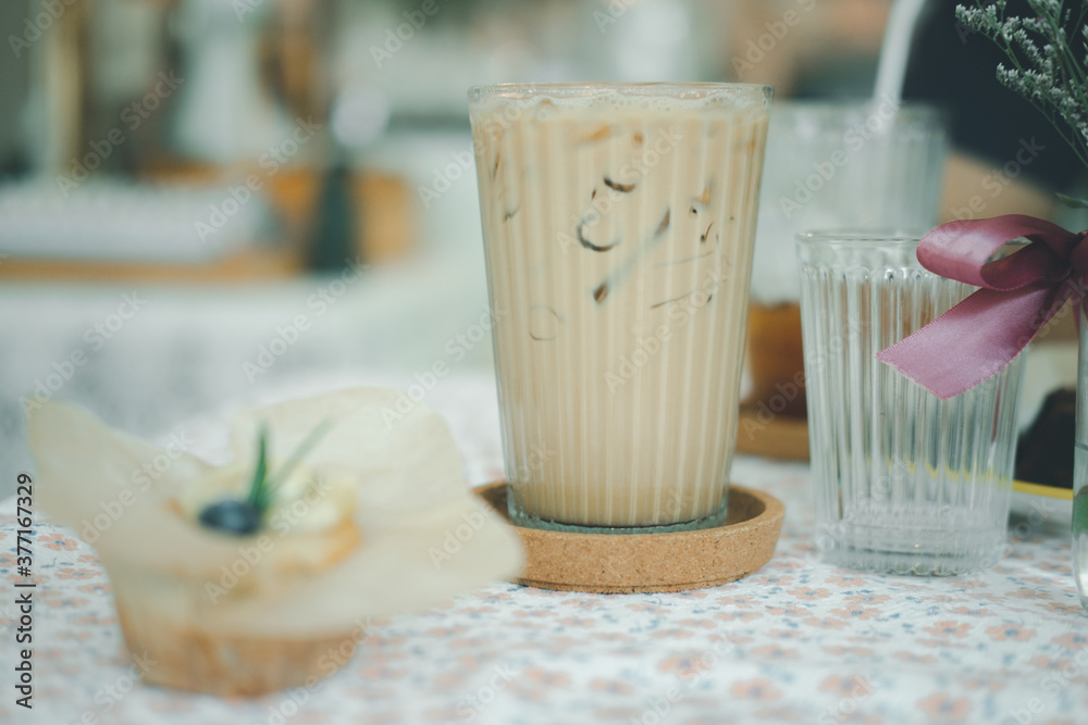 Iced latte coffee in glasses on table served with banana cake