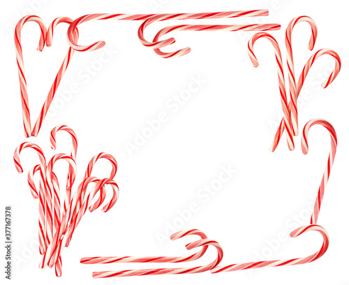 Frame of tasty Christmas candy canes on white background