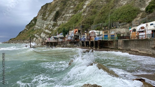 The Passetto beach during storm with the famous Grotte, they are the shelter of small fishing boats. photo