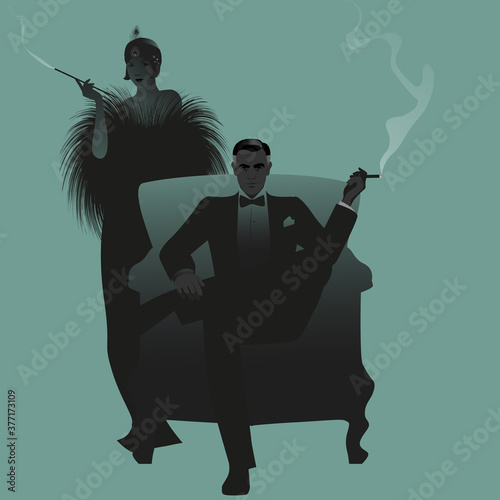 Elegant couple dressed in retro party clothes smoking cigar and pipe. Flapper and gentleman