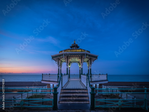 A spectacular dawn rises behind the bandstand on Brighton seafront