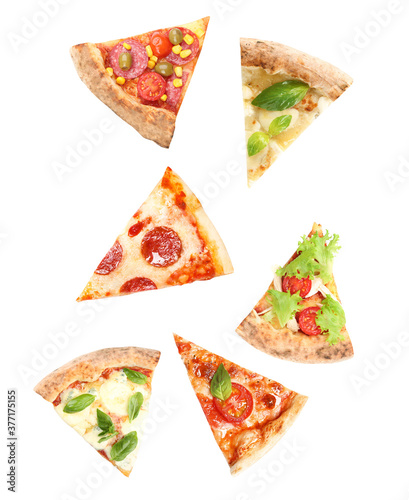Pieces of different pizzas falling on white background