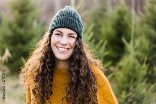 portrait of beautiful teenage girl with long curly hair and a beanie
