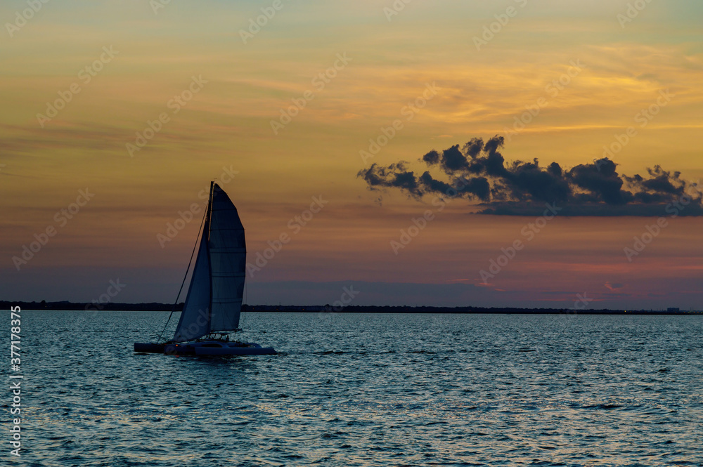 Holiday lifestyle landscape with skyline yacht sailing against sunset sailboat tourism maritime evening walk