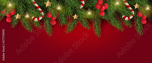 Merry Christmas and Happy New Year. Christmas banner design of tree branches with berries, gold stars, candy canes and decorated in red background. 
