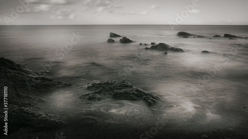 black and white sea trails rocks