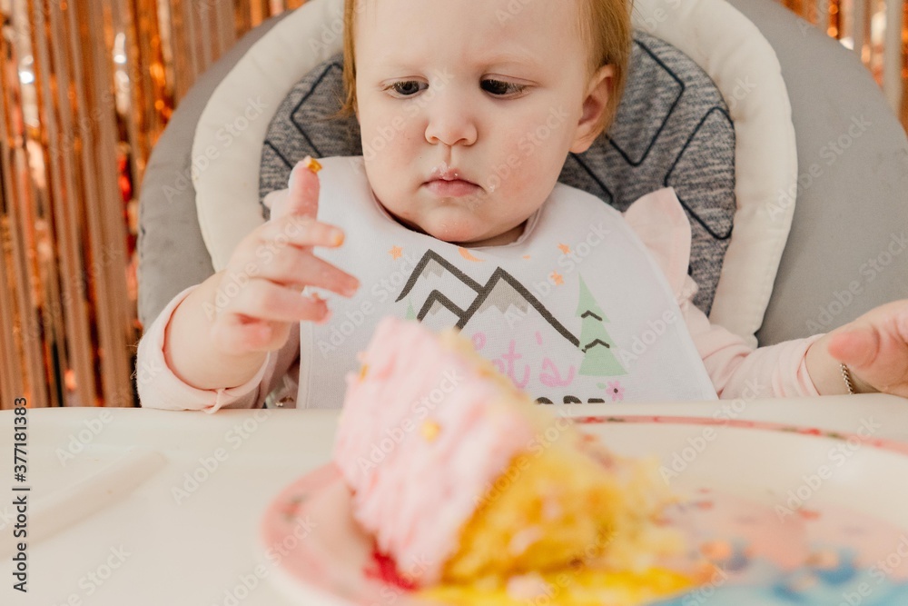 baby girl eating her birthday cake baby girl eating her birthday cake