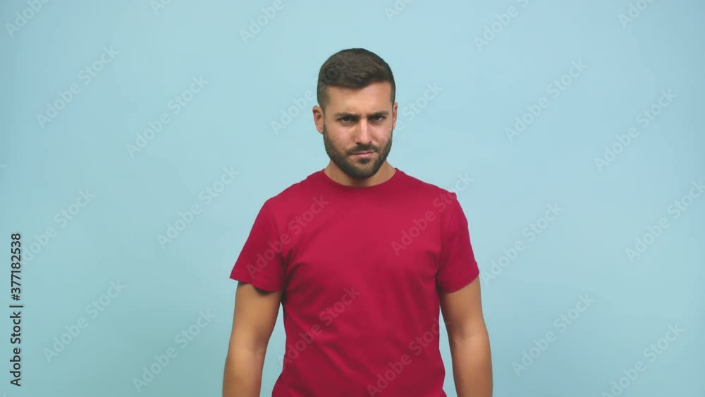 Young caucasian handsome man serious and determined, putting hand in front, stop gesture, deny concept Young caucasian handsome man serious and determined, putting hand in front, stop gesture, deny concept