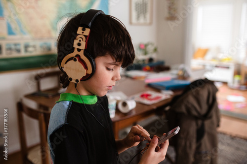 boy listens to music on headphones