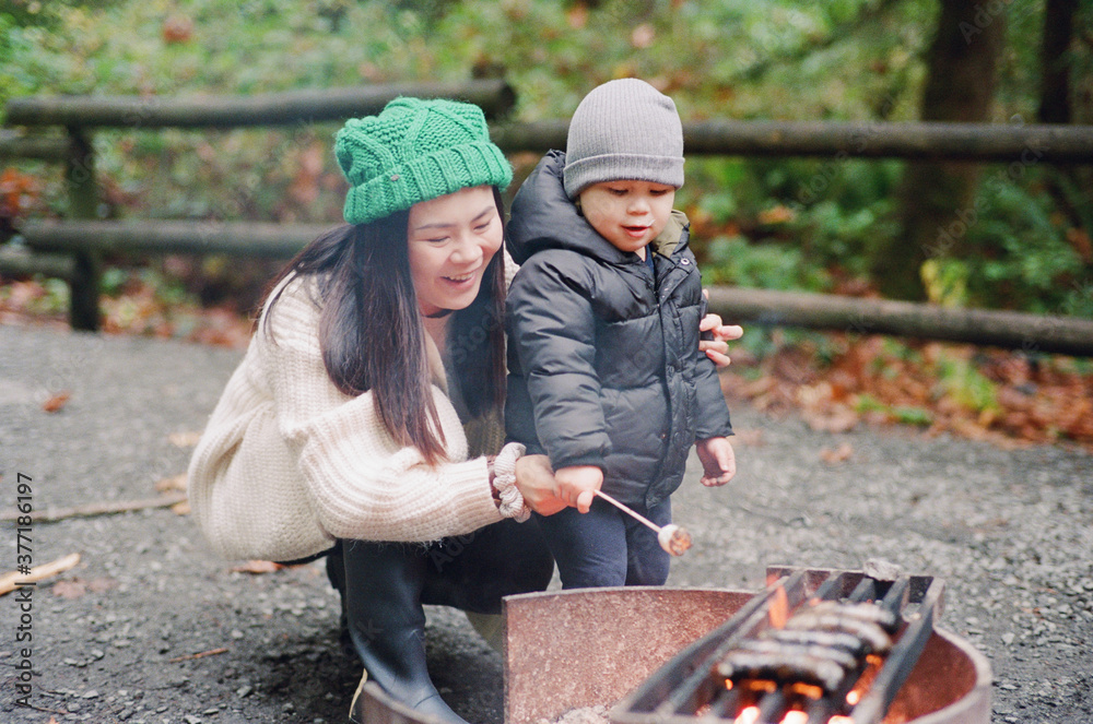 Chinese Mother And Son Enjoying A Campfire Chinese Mother And Son Enjoying A Campfire