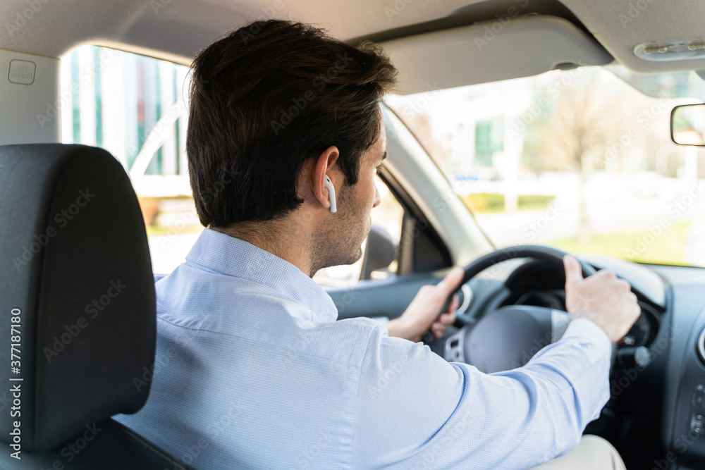 Young businessman sitting in taxi and using laptop Young businessman sitting in taxi and using laptop