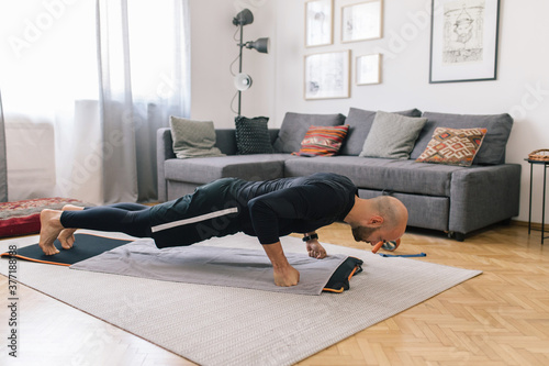 Young man doing home workout photo