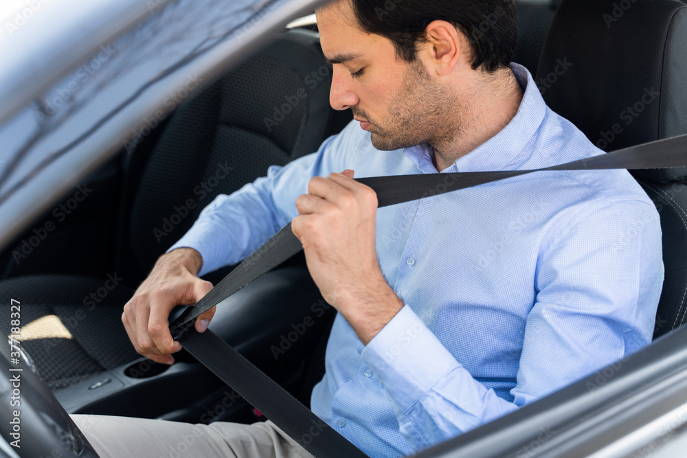 Young businessman sitting in taxi and using laptop Young businessman sitting in taxi and using laptop