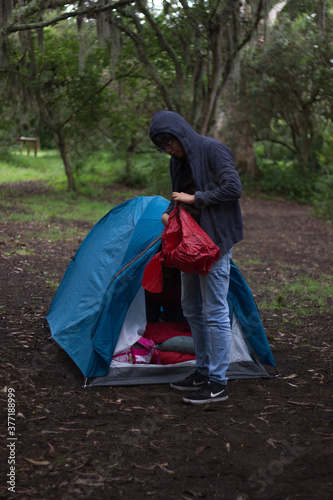 Man in a camping tent packing his storage