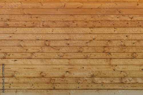 wall of brown wooden planks arranged horizontally