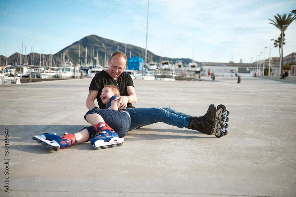 Father and son with roller skates Father and son with roller skates