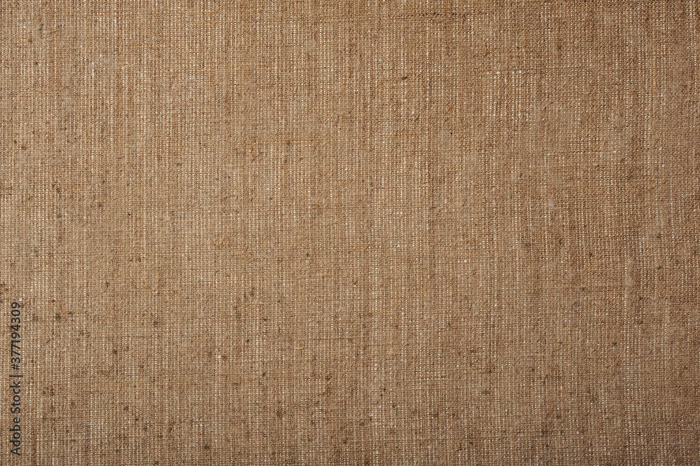 
a piece of artistic natural rough brownish canvas.