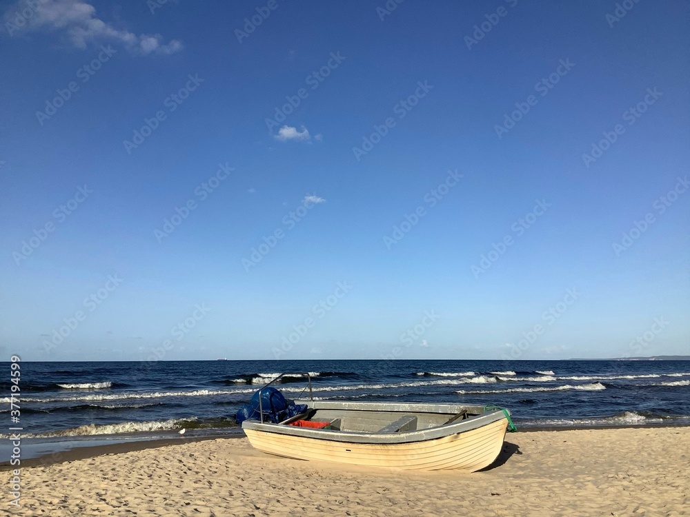 Single wooden fishing boat on the beach