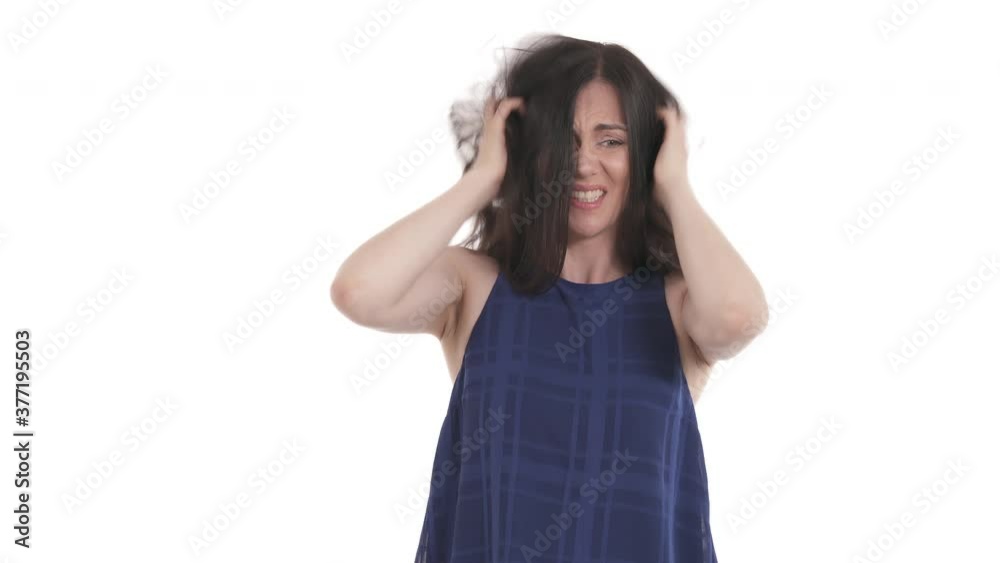 Young Caucasian woman scratching her head. Suffering from dermatology disease or neurological problems. Healthcare concept. Isolated on white background. Young Caucasian woman scratching her head. Suffering from dermatology disease or neurological problems. Healthcare concept. Isolated on white background.