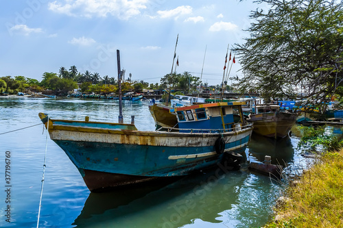 A traditional fishing boat rests on the banks of the lagoon in Negombo  Sri Lanka after an early morning fishing trip
