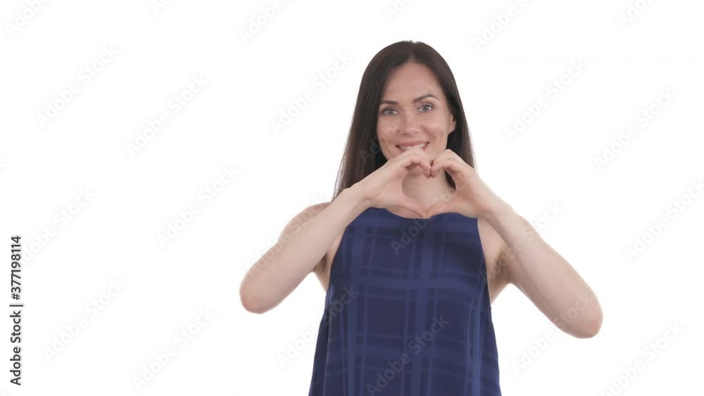 Portrait of Caucasian woman making a heart gesture with fingers. Symbolic of love. Hand heart sign. Isolated on white background Portrait of Caucasian woman making a heart gesture with fingers. Symbolic of love. Hand heart sign. Isolated on white background
