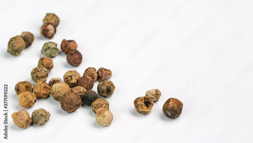 Dry green peppercorns isolated on white background board, closeup view Dry green peppercorns isolated on white background board, closeup view