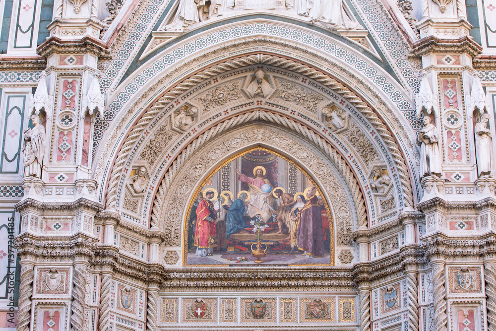 A beautiful decorative painting on panel above the entrance door at the Duomo Santa Maria del Fiore, (Cathedral of Saint Mary of the Flower) in Florence, Italy