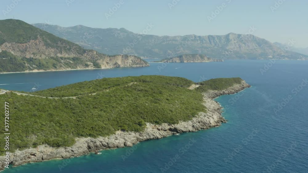 Aerial view over cape of Montenegro near Budva. Drone shot over the cove Adriatic Sea with beautiful mountain landscape. Aerial view over cape of Montenegro near Budva. Drone shot over the cove Adriatic Sea with beautiful mountain landscape.