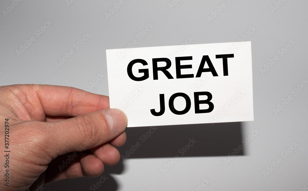 Message on the card GREAT JOB, in hands of businessman. Message on the card GREAT JOB, in hands of businessman.