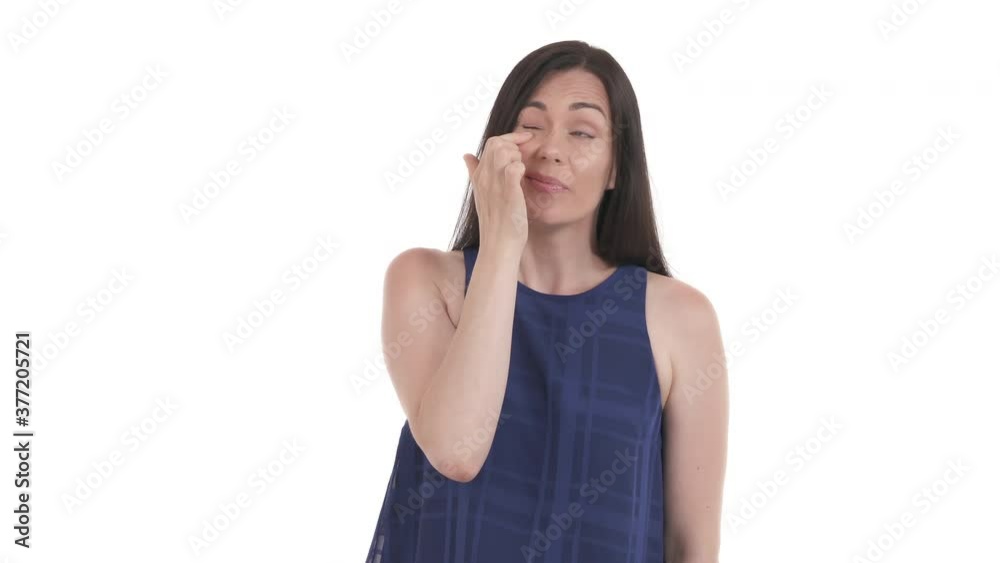 Caucasian woman blinking frequently and rubbing eye. Lady got something in her eye. Eye irritation. Isolated on white background Caucasian woman blinking frequently and rubbing eye. Lady got something in her eye. Eye irritation. Isolated on white background