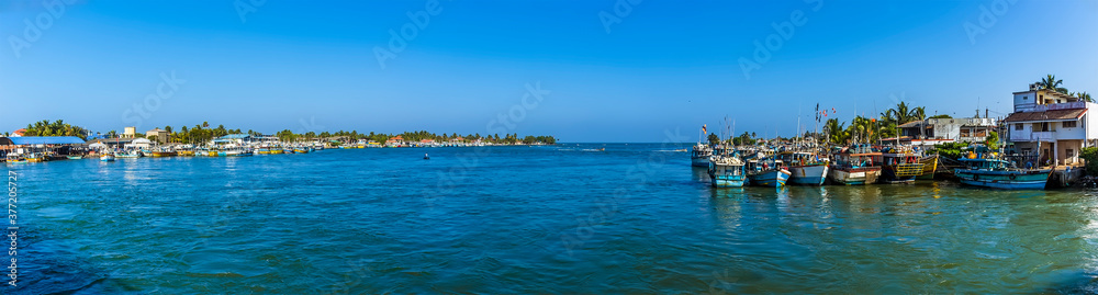 A panorama view of boats moored in the lagoon in Negombo, Sri Lanka after returning from an early morning fishing trip