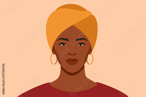 Black girl is wearing a yellow turban. Self-confident young woman with brown skin in traditional headdress portrait front view. Vector illustration. African female with a scarf on her head.