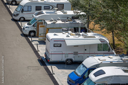 View of motorhomes parked on the side of the road in foreign tourists campsite