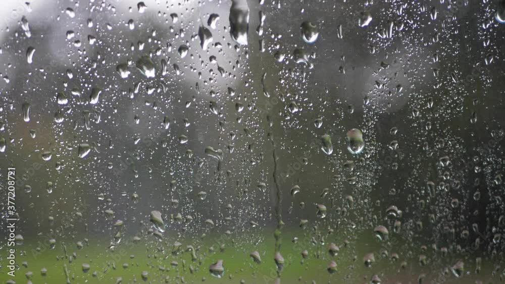 Raindrops on the glass fall down Raindrops on the glass fall down